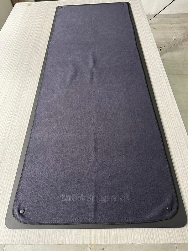 The delivered Snapmat sample, towel snapped onto the mat